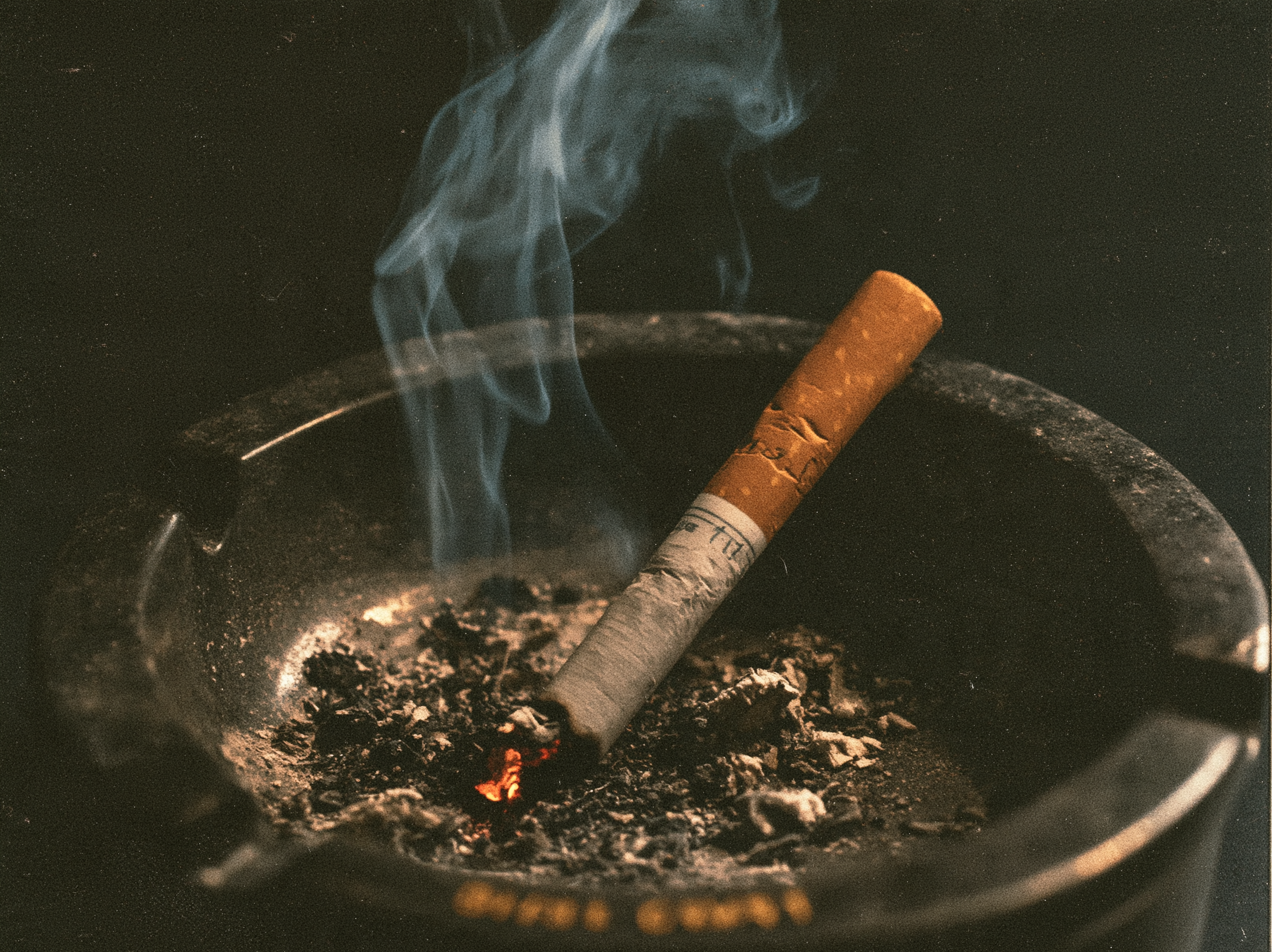 An image of a cigarette in an ashtray to represent cigarette smoke cleaning